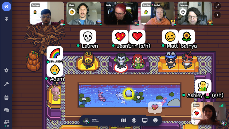 Several people on the Clients team around a table using various custom emotes. The emotes that appear over their avatars heads alsoo appear in their video on the left side udner their name 